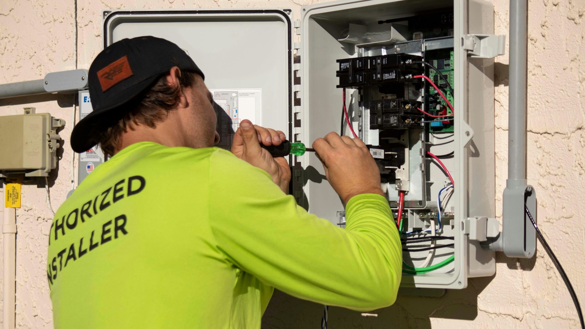Licensed electrician working on electrical panel installation