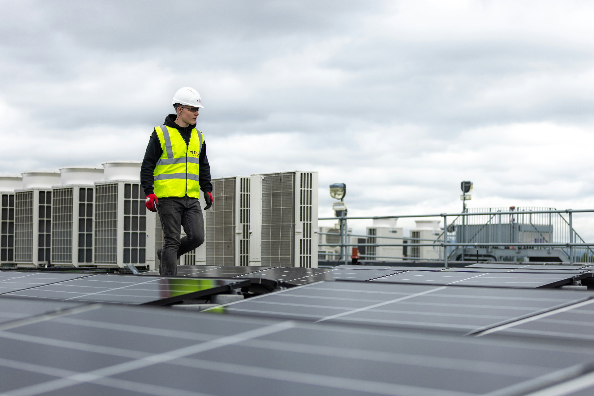 HVAC and electrical trades professional on commercial rooftop installation